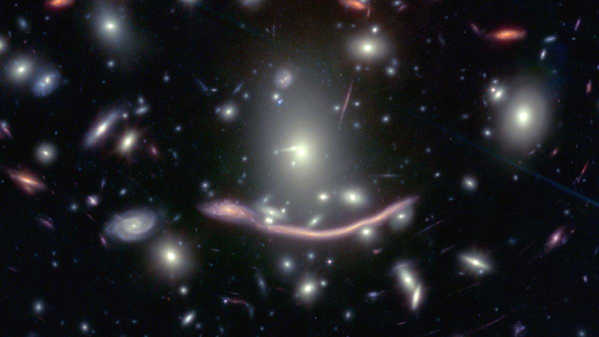 multiple galaxies with long smear of light in middle