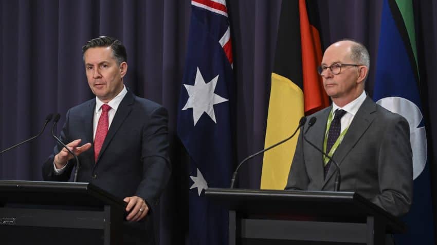 Mark butler and paul kelly stand at podiums