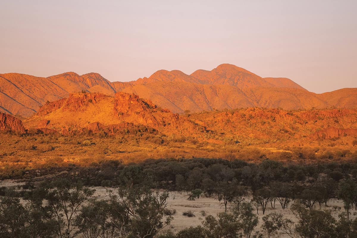 Red mountains from mt sonder lookout, in a bush setting.