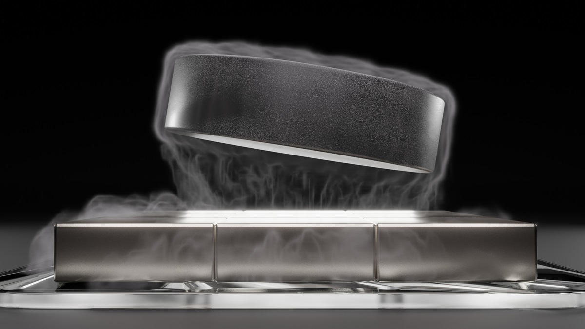 Superconducting material hovering over a set of magnets with smoke and black background