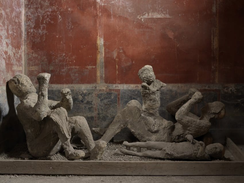 A photograph of 3 plaster casts of people