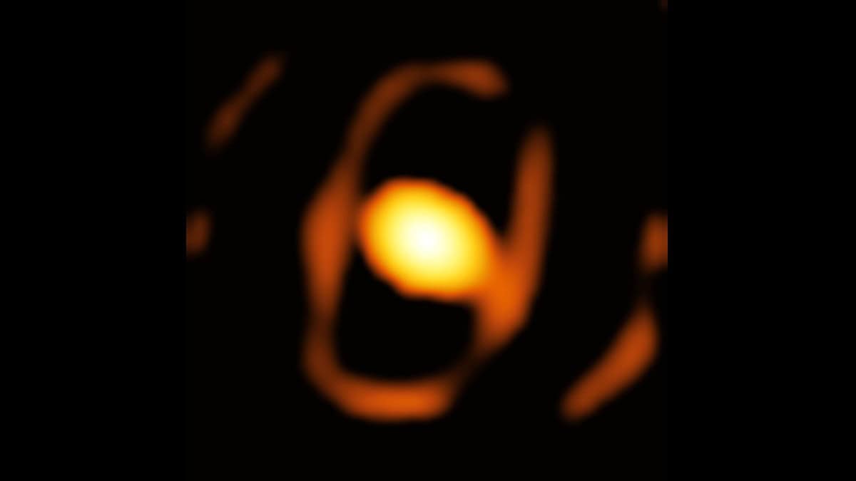 Image of distant star with egg shaped cocoon