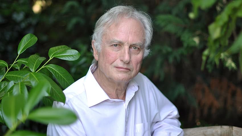 Richard dawkins: man in white shirt standing among plants