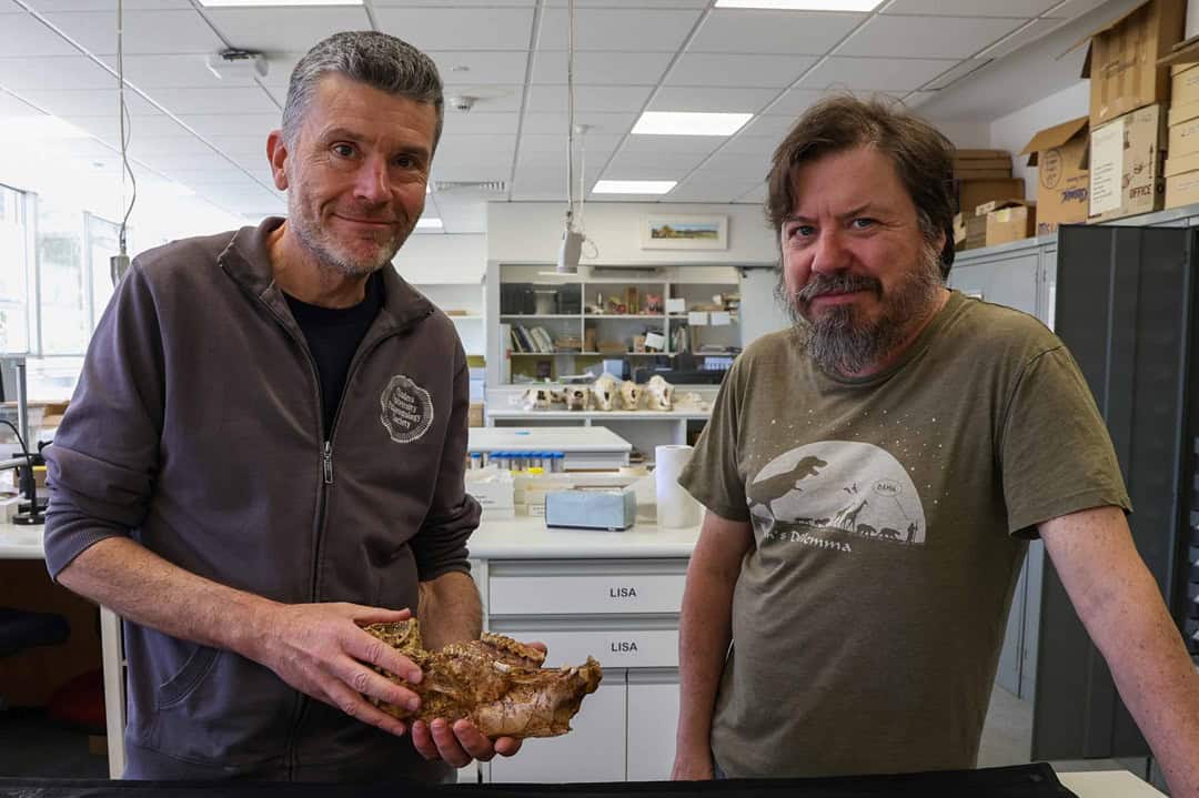 Two palaeontologists holding kangaroo jaw bone