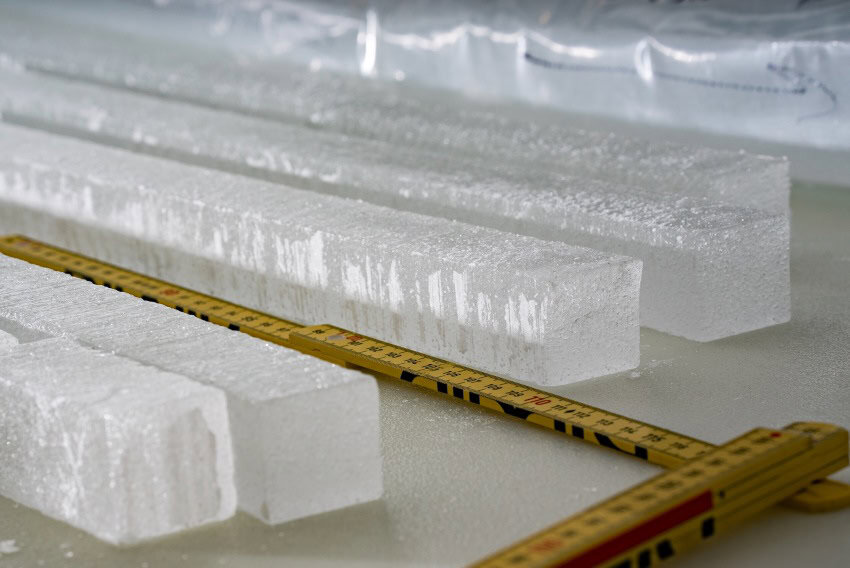 5 cubic ice cores laid out next to a yellow measuring ruler