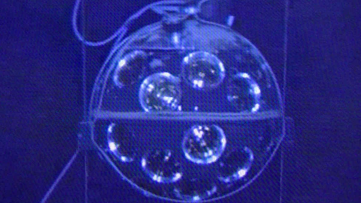 Blue image of spherical optical detector on sea floor