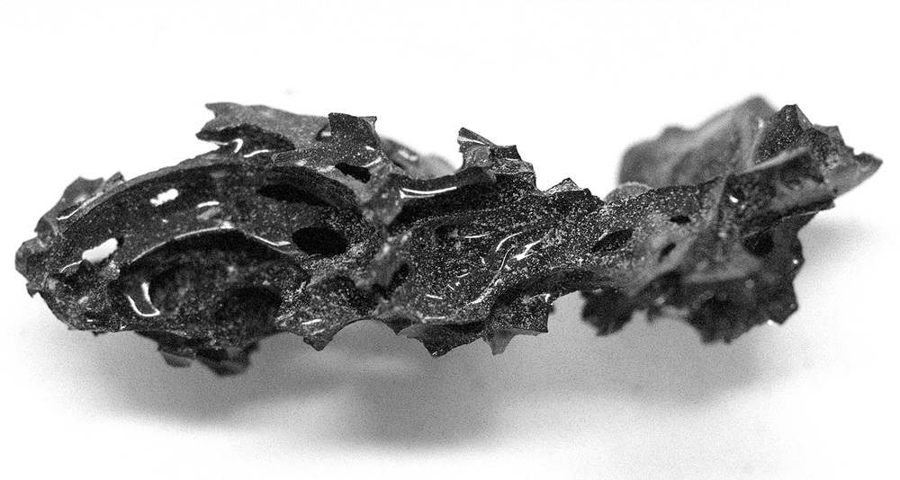 Fragment of dark glass on white background