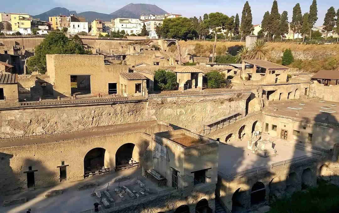 Archaeological site at herculaneum with vesiuvius in background