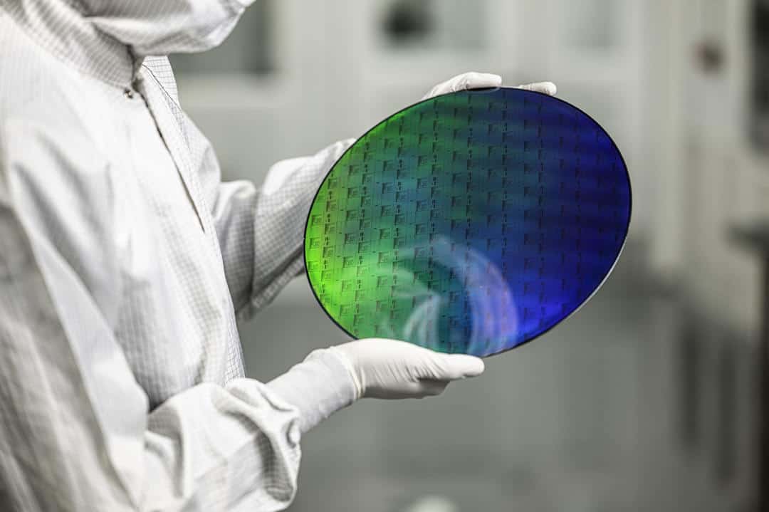 Lab scientist holding optical wafer