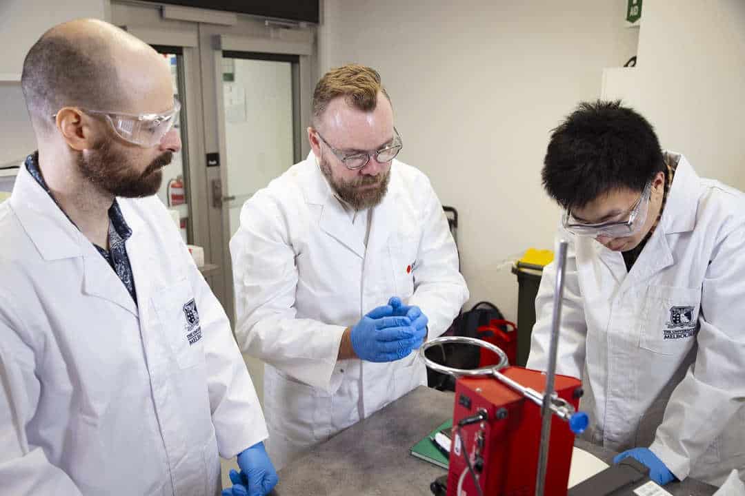 Three scientists in lab coats