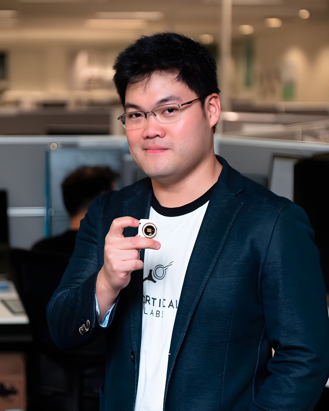 Person holding computer chip in office