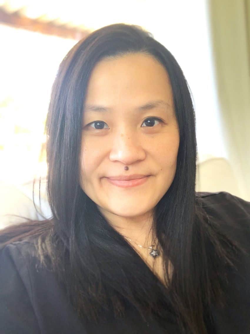 Head and shoulders shot of flora salim. A woman with dark straight hair, wearing a black jacket.