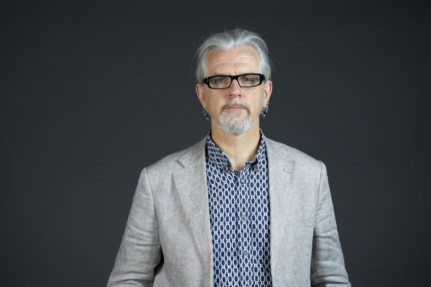 Head and shoulders shot of robert sparrow. Male with grey hair and goatee, wearing black rectangular spectacles and a grey suit jacket.