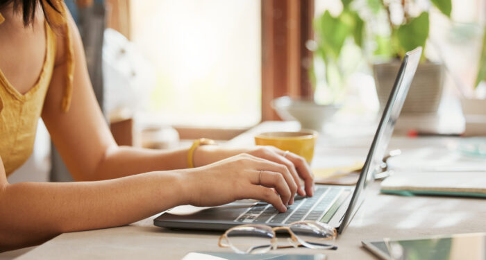 Computer, woman hands and online working of a remote employee with code work at home. Web research, internet and pc writing of a female freelancer typing on a laptop planning for coding writer job.