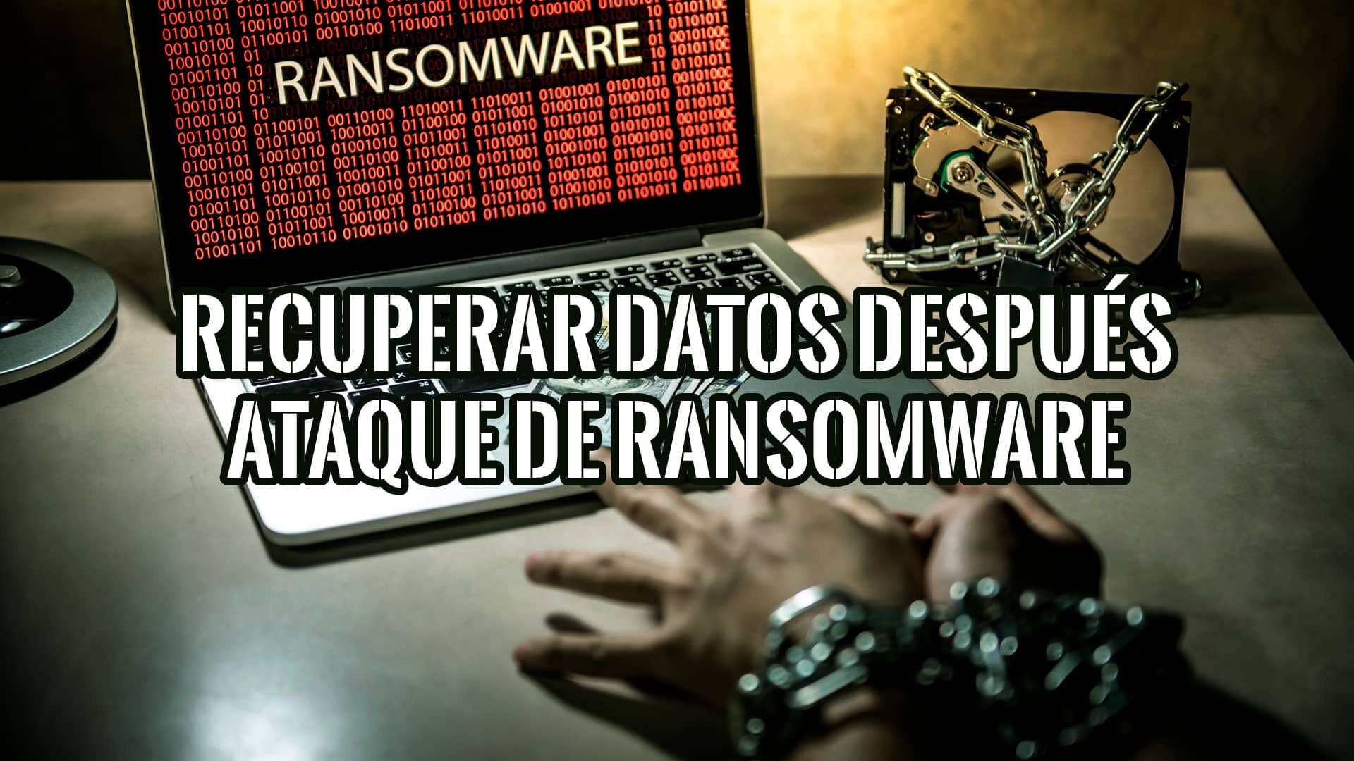 Imagen de un portátil con la palabra "Ransomware" en la pantalla, un disco duro con cadenas y unas manos atadas con cadenas.