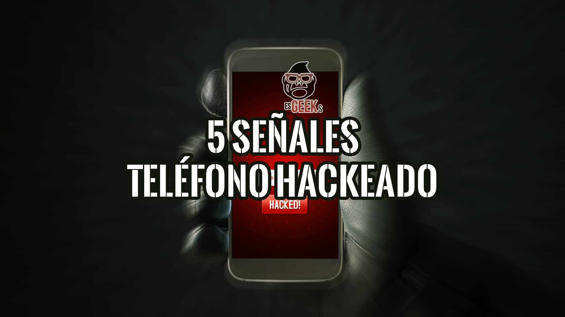Una mano con guante oscuro sosteniendo un smartphone cuya pantalla muestra el título "5 SEÑALES TELÉFONO HACKEADO" y el logo de "esGEEKS", con una advertencia "HACKED!" en rojo en la parte inferior.