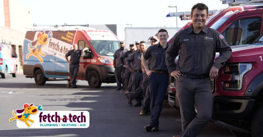 A group of friendly Fetch‑A‑Tech team members, proudly wearing their uniforms, stand together beside our branded service vehicles in a Las Vegas parking lot. Their warm smiles and team spirit reflect our honest, family-owned commitment to helping local families stay comfortable. The company logo is visible in the foreground, welcoming you to learn more about how we serve the Las Vegas community.