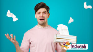 A concerned man holds a tissue box while tissues scatter around him, suggesting discomfort in his Las Vegas home. The Fetch‑A‑Tech Plumbing, Heating & Air logo appears in the corner, highlighting our family-owned team’s commitment to providing honest, reliable comfort and helpful service when you need it most.