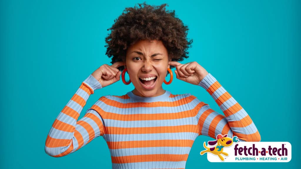 A person in a striped shirt covers their ears and squints, clearly uncomfortable, against a blue background—showcasing the need for relief from household noise or discomfort. The Fetch‑A‑Tech plumbing and HVAC logo appears in the bottom right corner, highlighting our commitment to bringing comfort and honest service to families throughout Las Vegas.