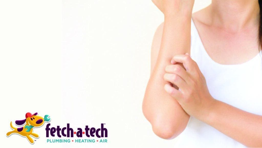 A person in a white shirt gently scratches their forearm, symbolizing the need for comfort at home. The Fetch‑A‑Tech Plumbing, Heating & Air logo appears in the bottom left corner, representing our family-owned commitment to keeping Las Vegas families comfortable and cared for with honest, reliable service.