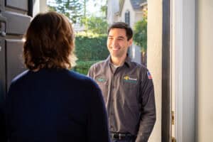 A friendly Fetch‑A‑Tech technician greets a homeowner at their Las Vegas doorstep, ready to help with honest, caring service.