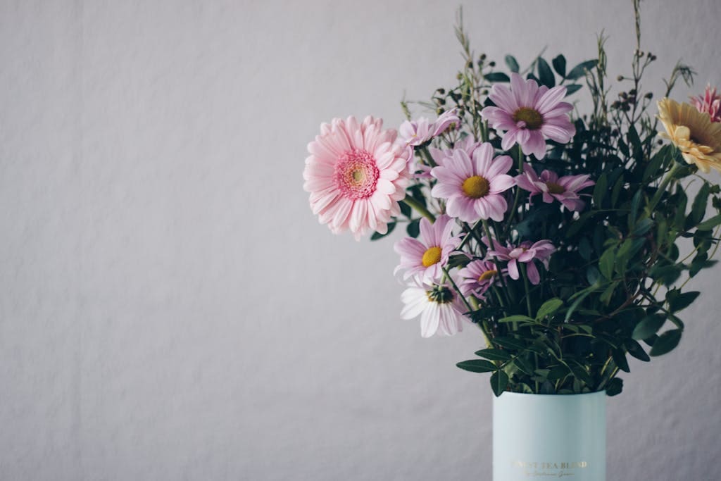 A stunning bouquet of pink gerbera daisies in a stylish vase against a soft background.