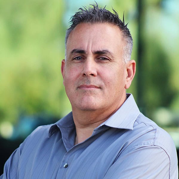 Headshot of a man in a gray shirt