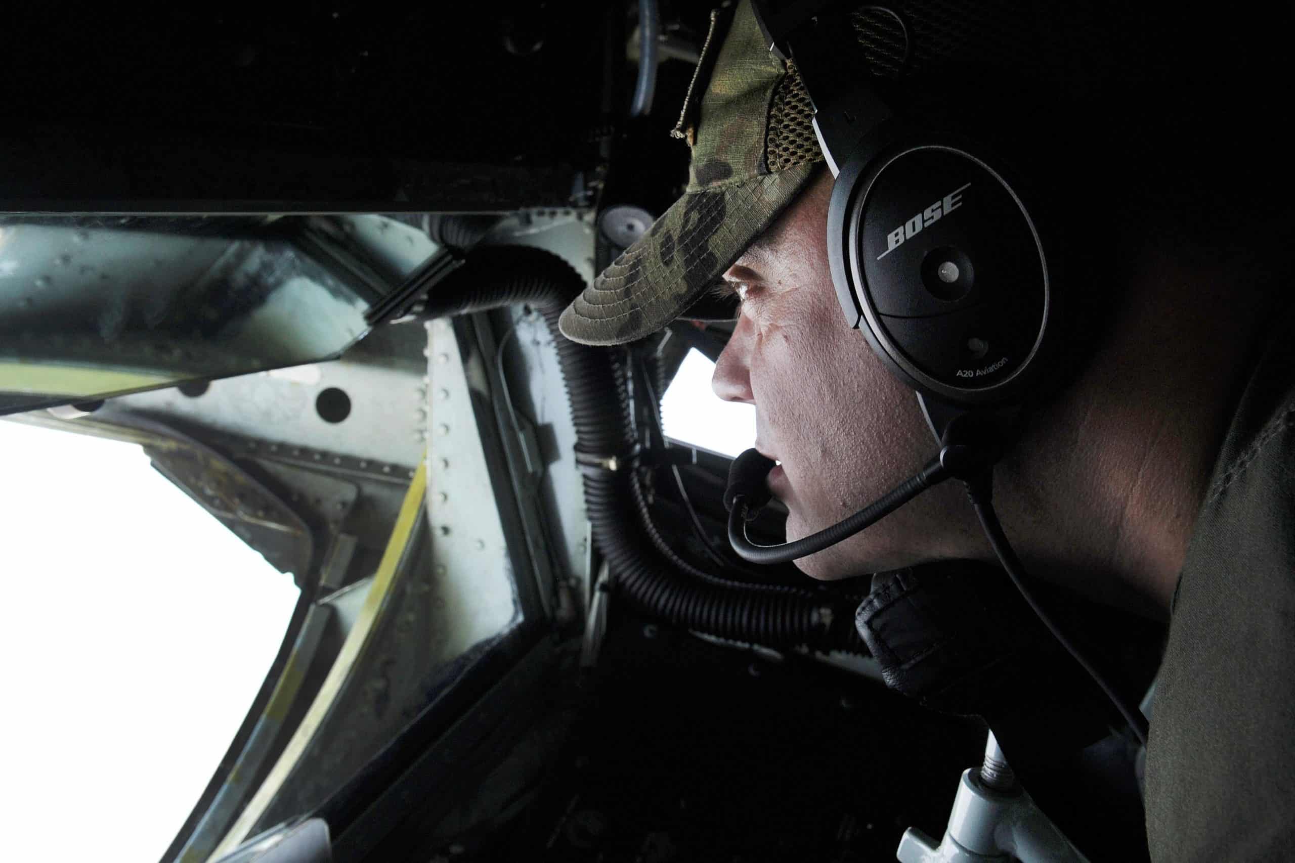 A pilot wearing a Bose aviation headset inside the cockpit