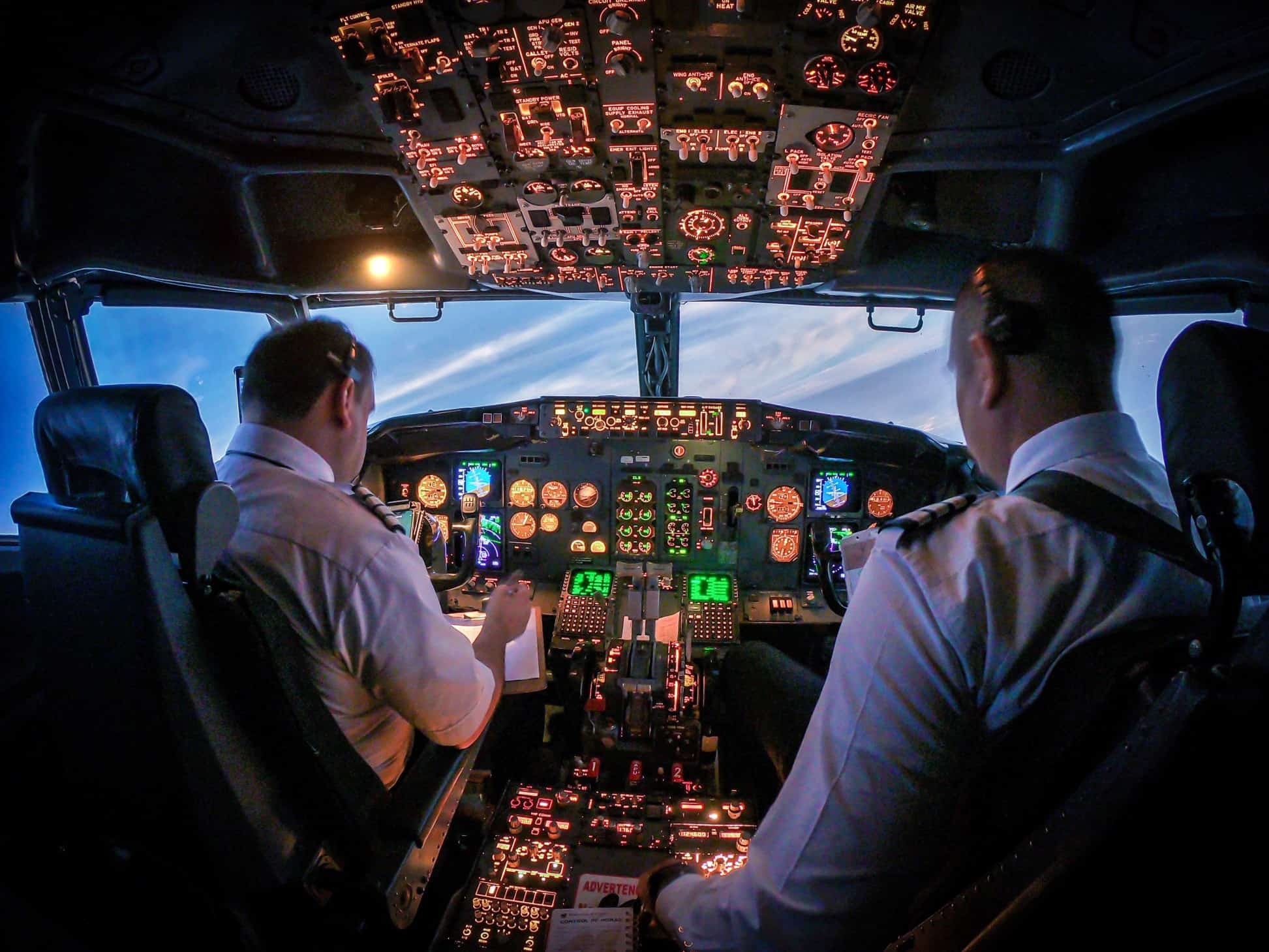 Two senior pilots inside a cockpit flying a plane