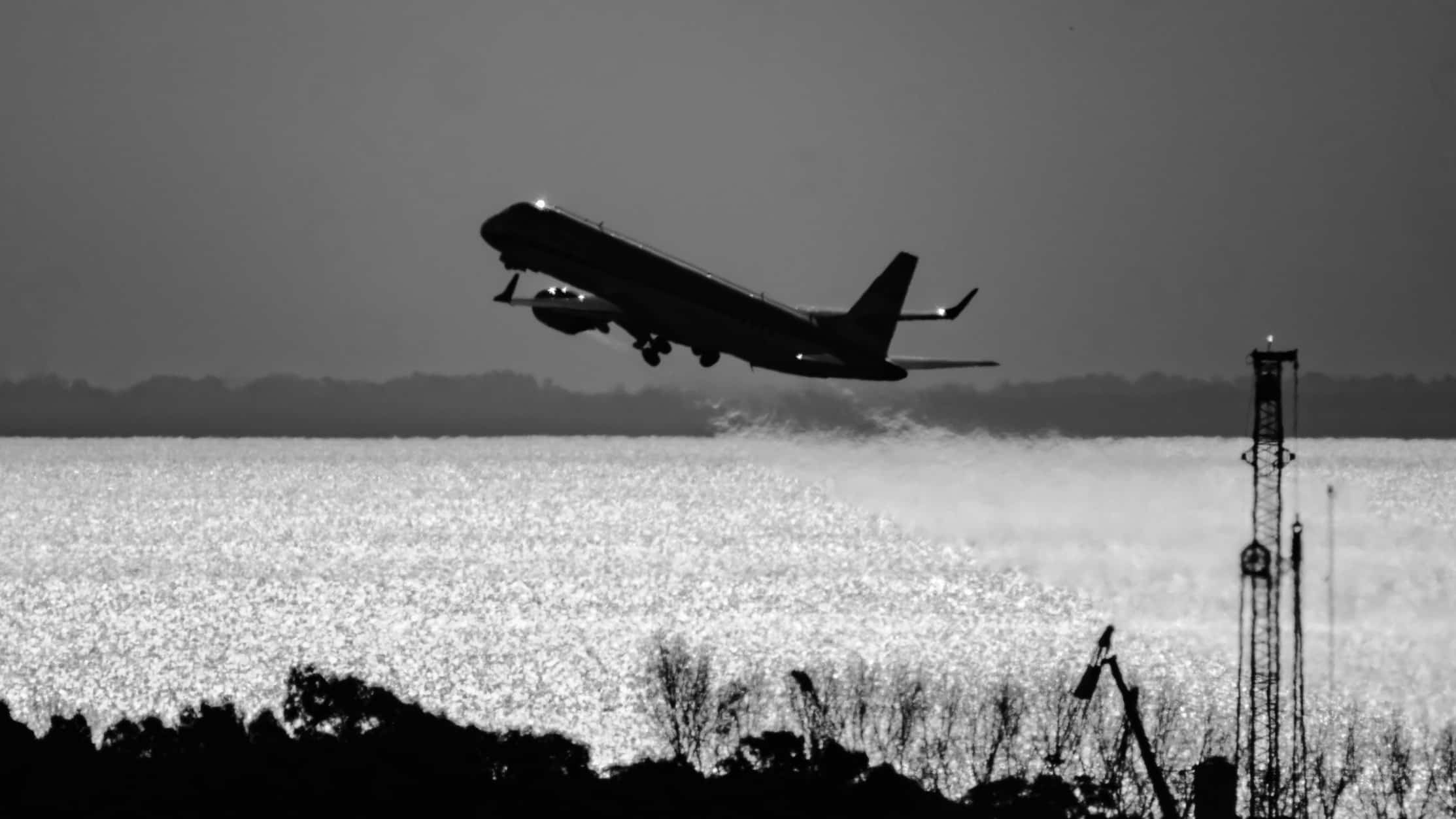 A commercial plane shortly after taking off. Photo in black and white