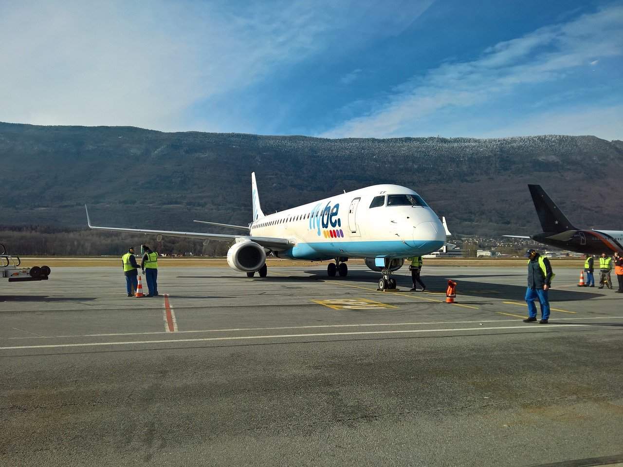 A plane on a runway in a mountainous region