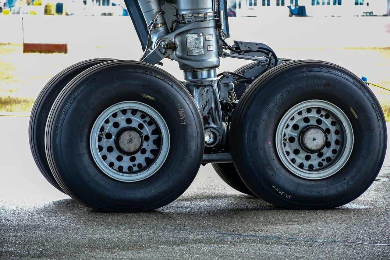 A closeup of airplane tires on a runway