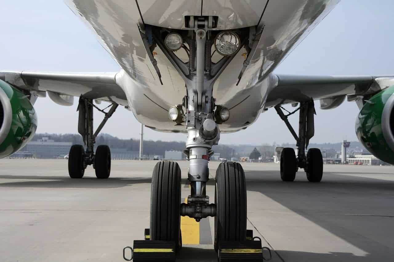 A frontend view of a plane's wheels on a runway