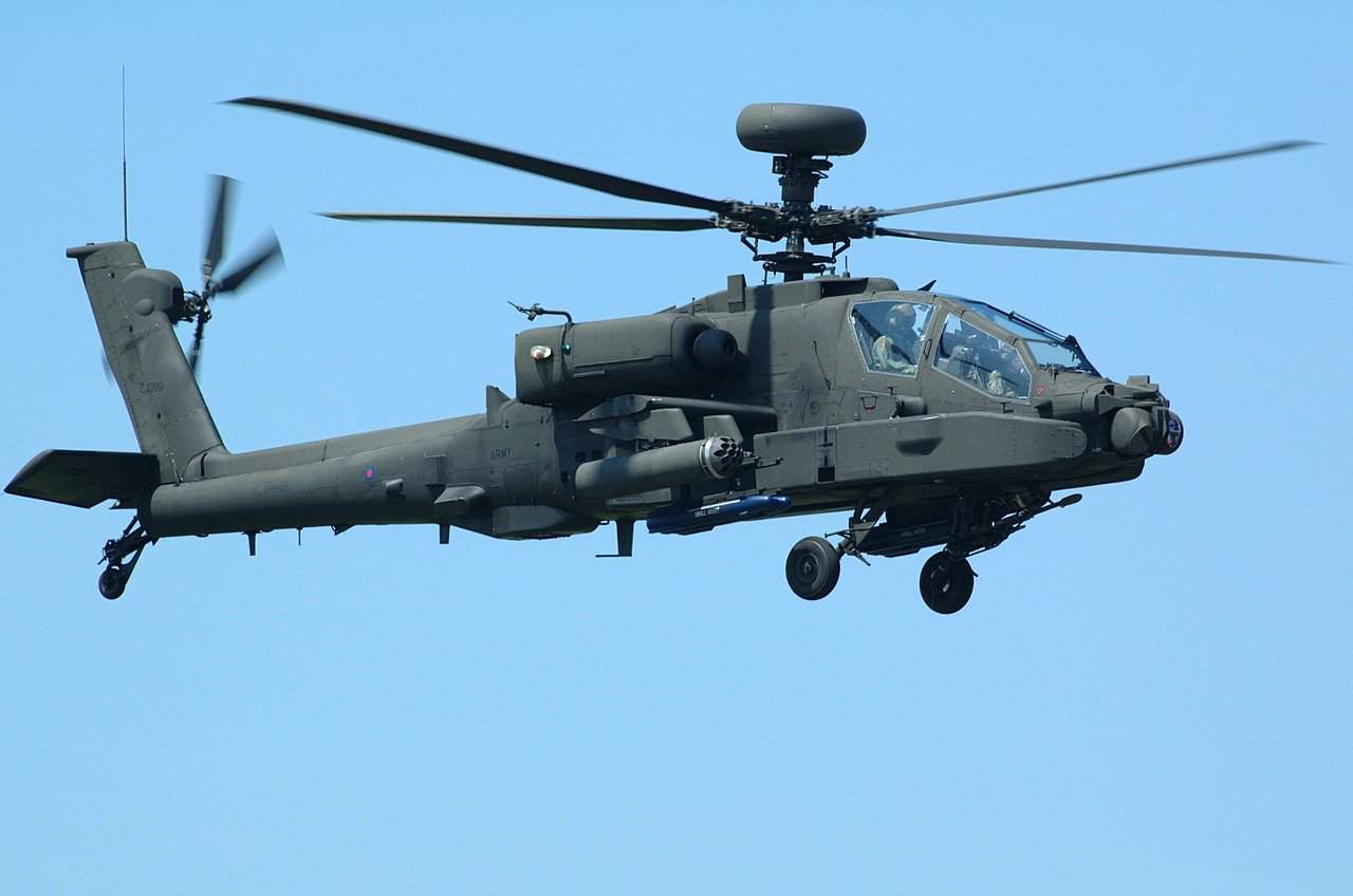 A military chopper flying in blue skies
