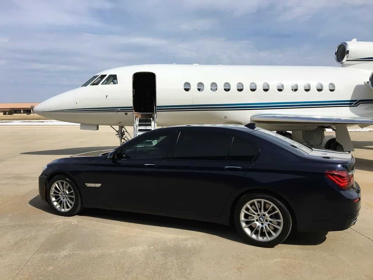 A private plane and luxurious car next to it