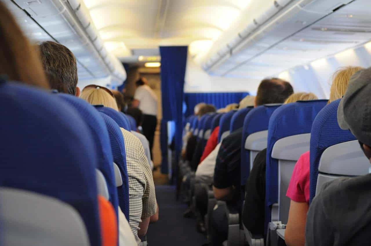 Passengers sitting on wide airplane seats