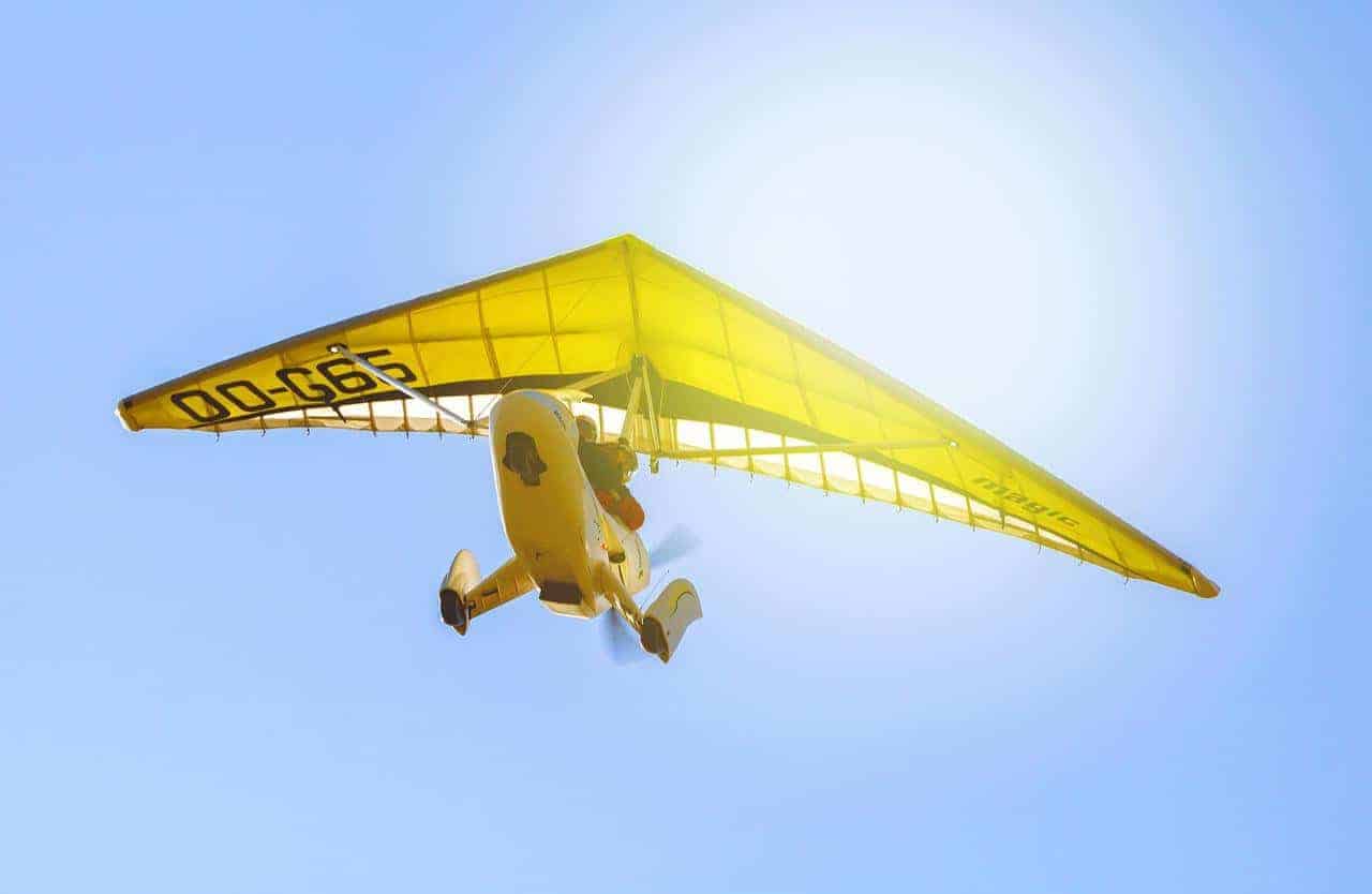 A small yellow plane cruising