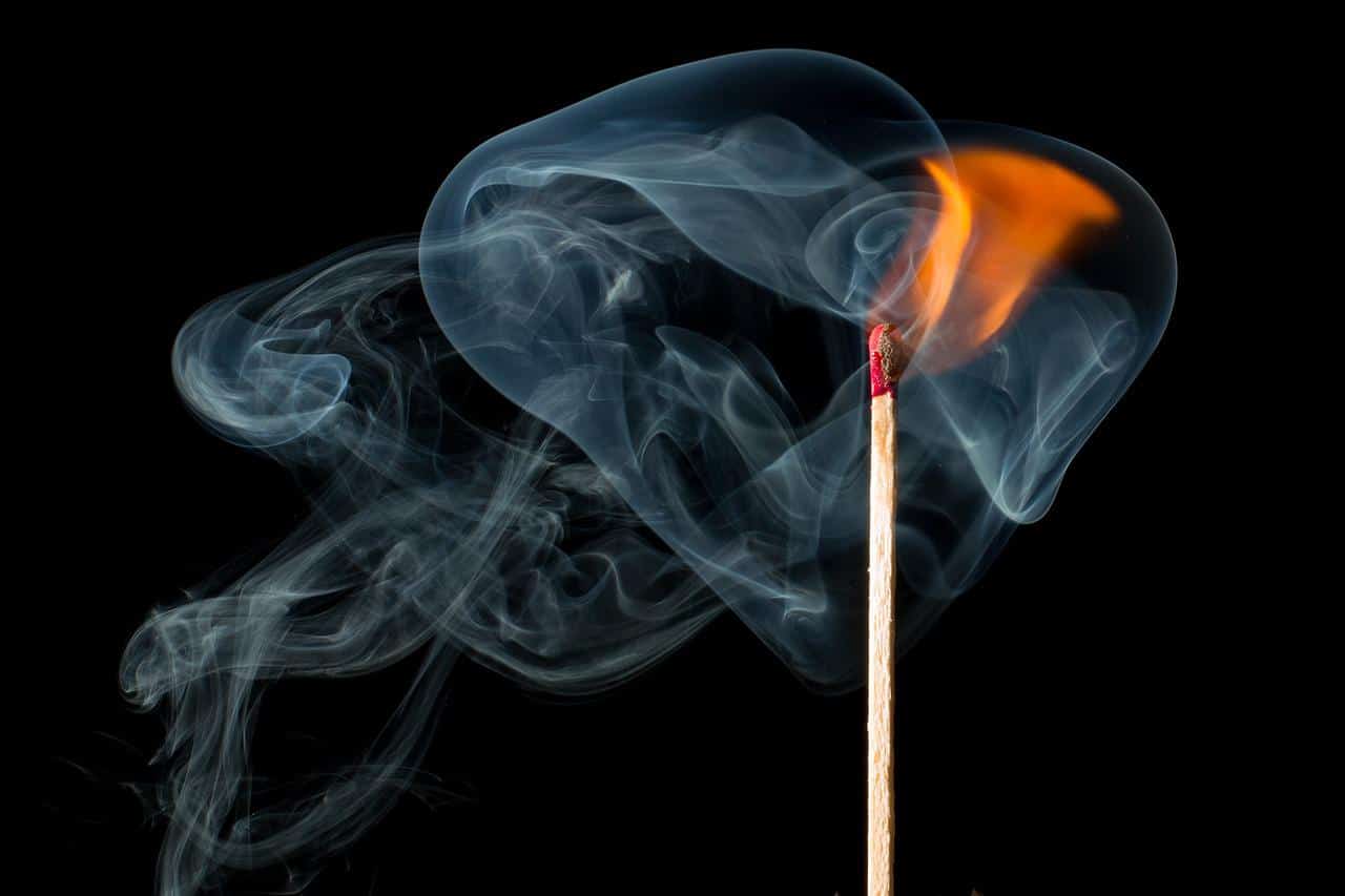 A lit match and smoke coming out of it