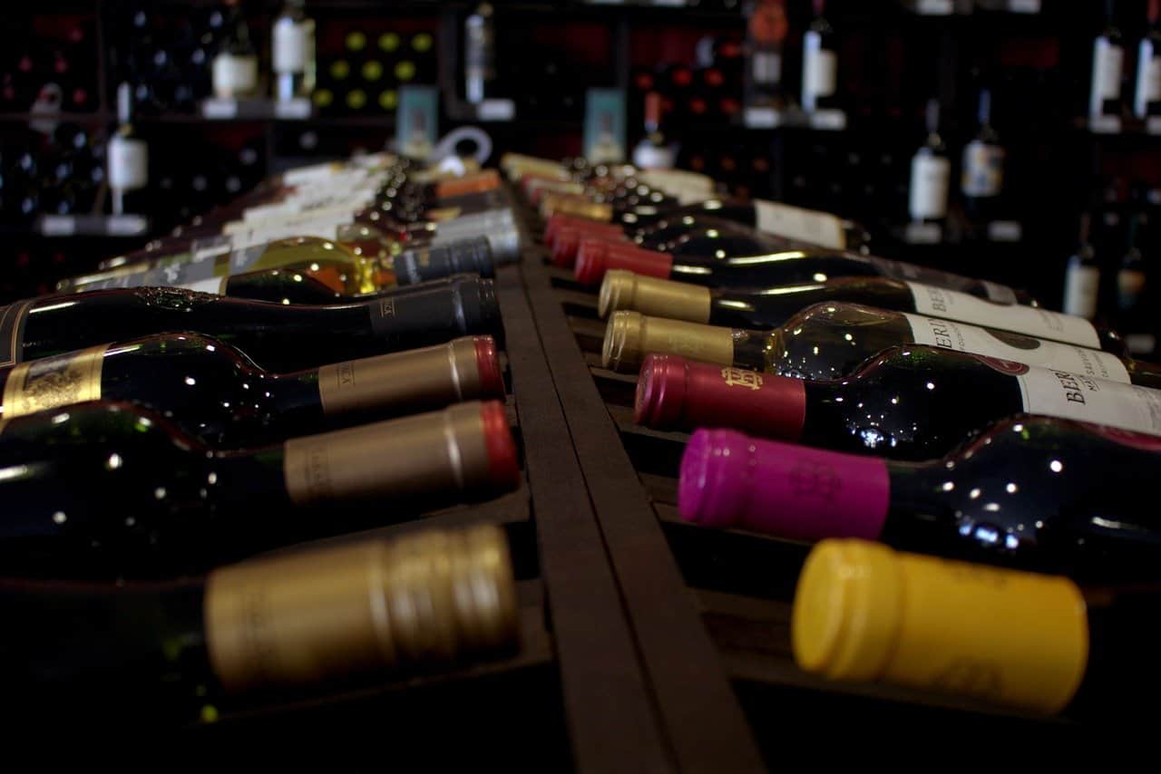 Over a dozen bottles of wine on a table