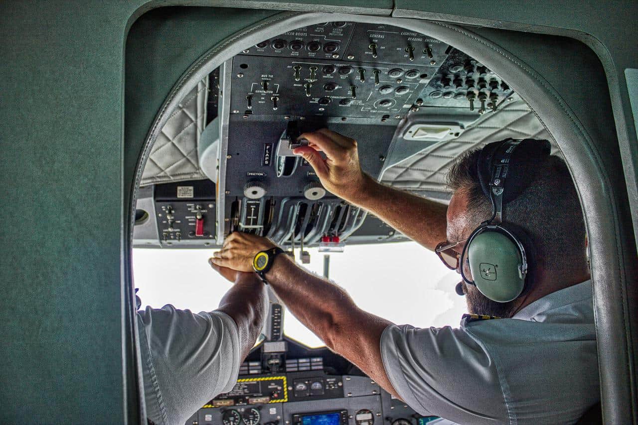 A co-pilot changing controls in the cockpit