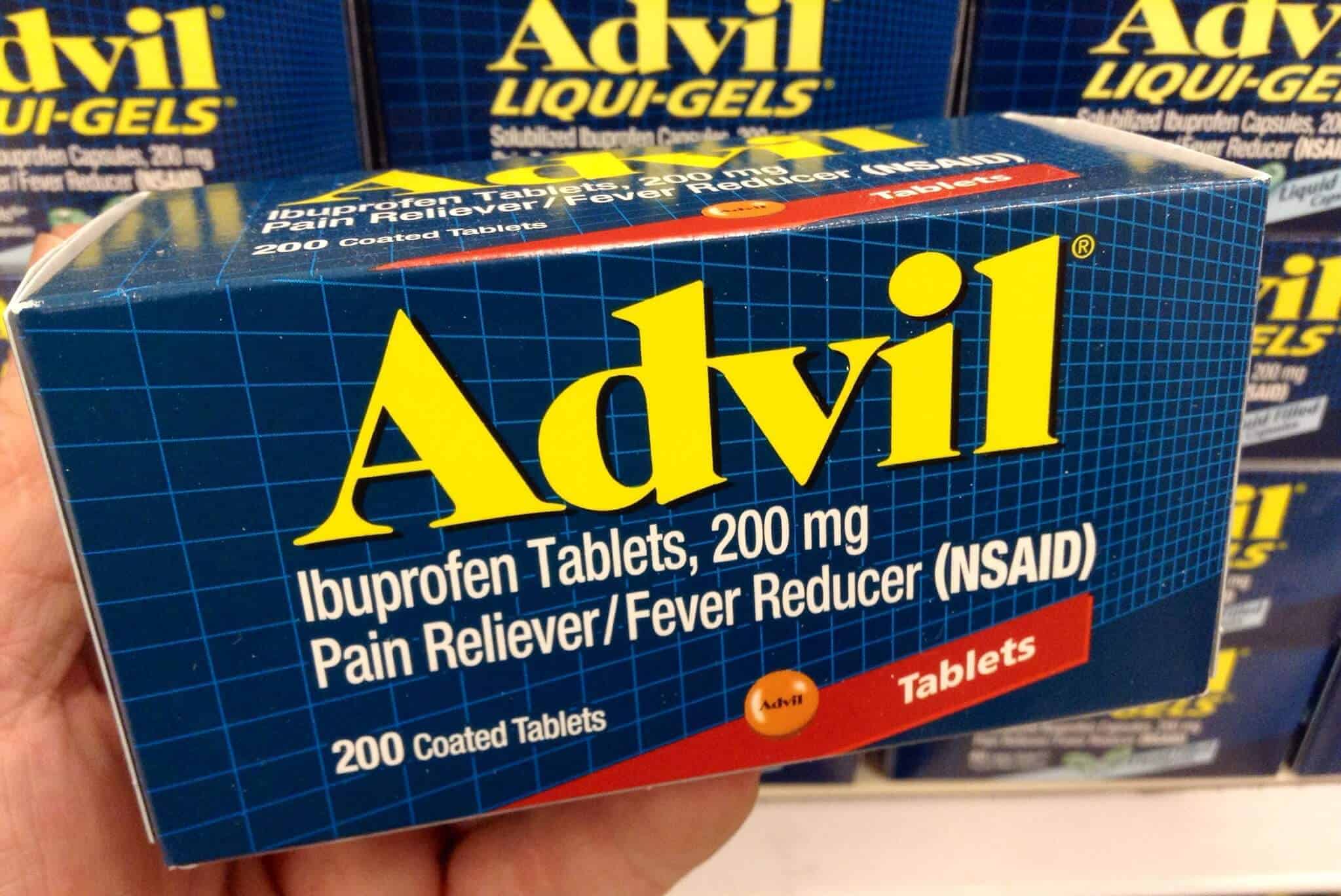 A man holding a box of Advil