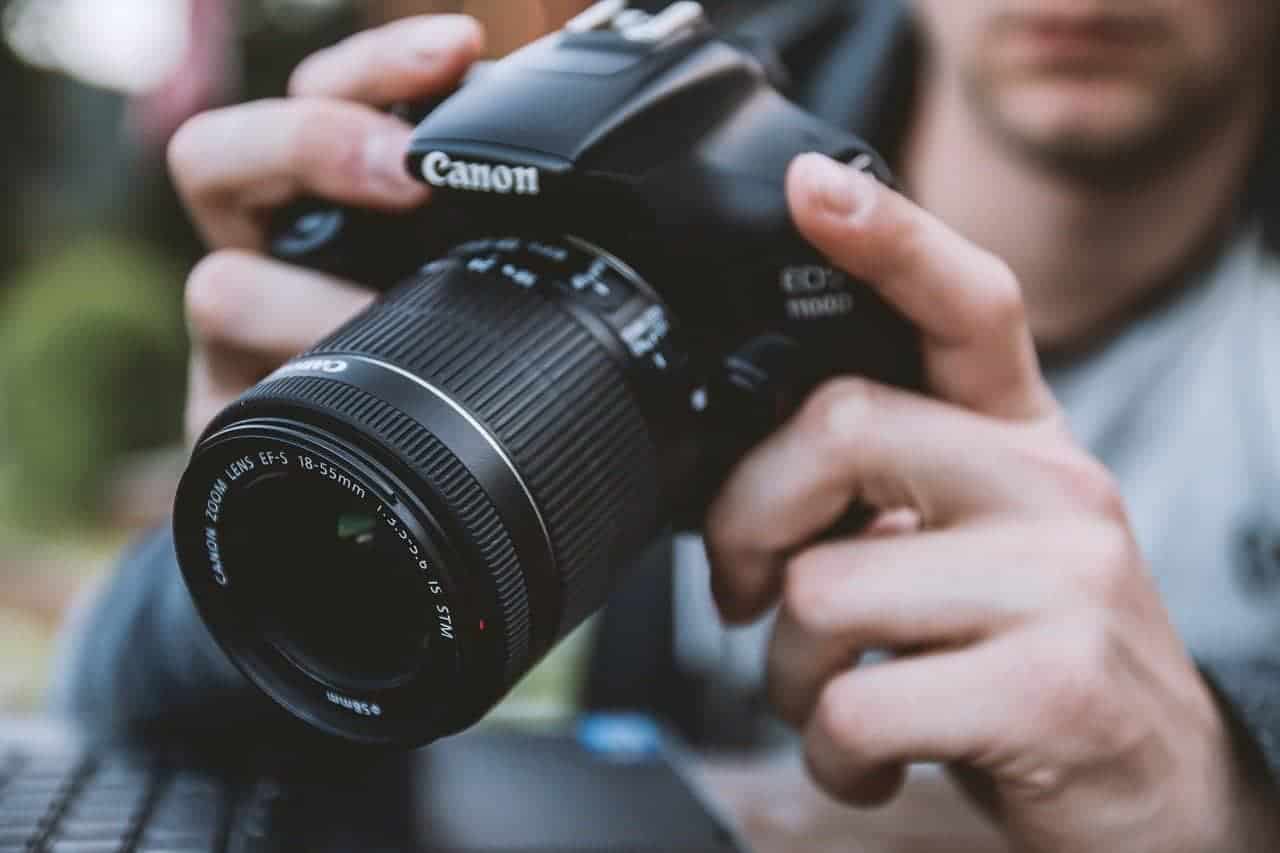 A man looking through the lens of his camera