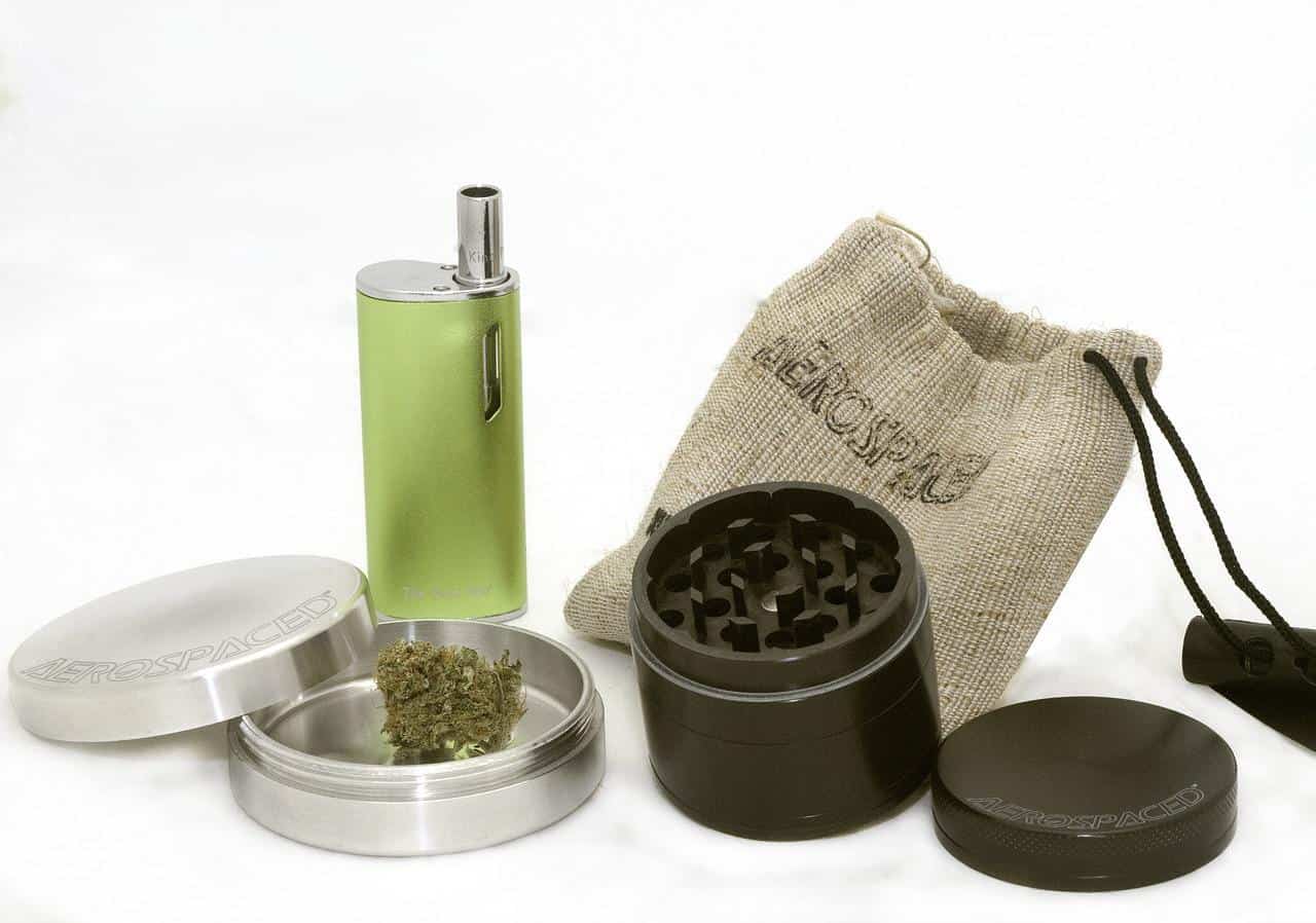 A grinder and weed next to each other