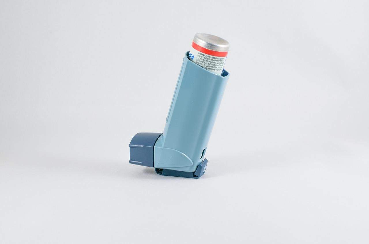 A blue inhaler on a table