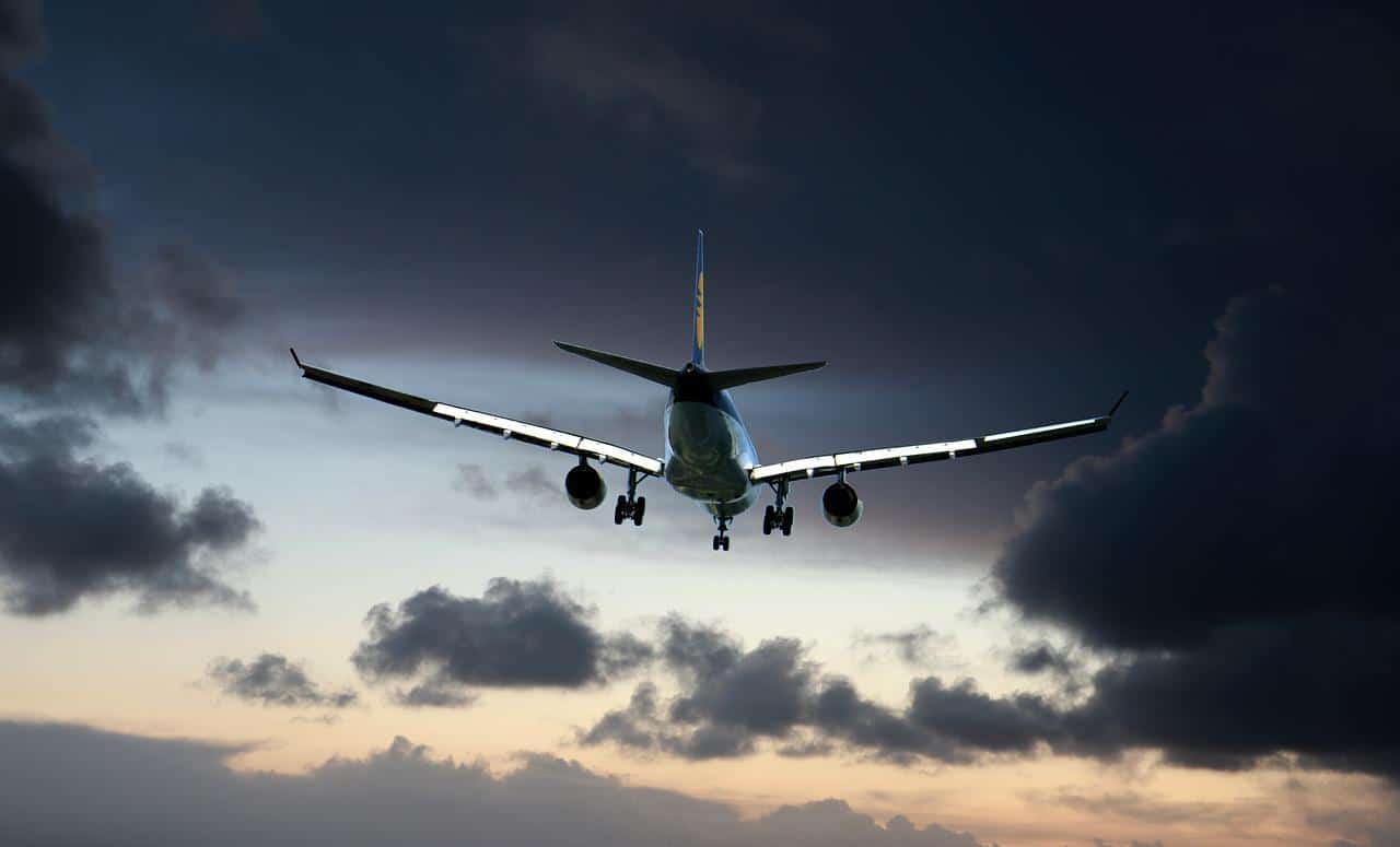 A plane approaching to land in dark skies