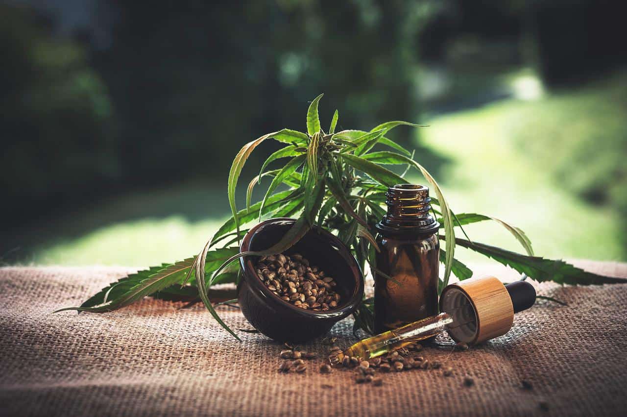 A bottle of opened CBD oil on a wooden table