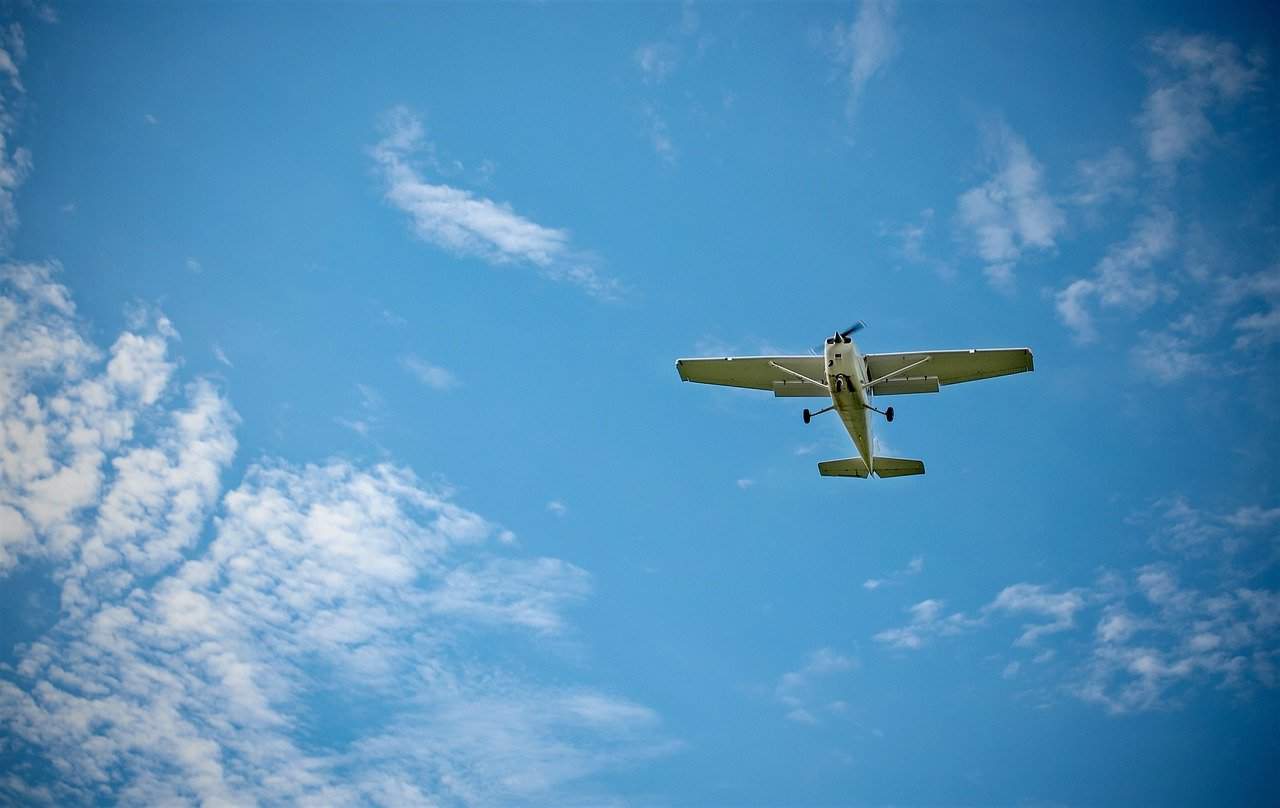 A small white plane flying under VFR