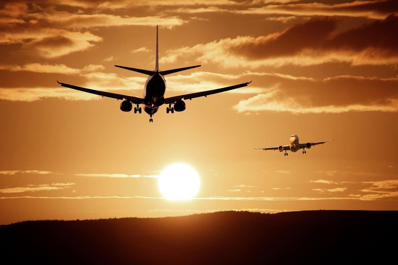 A plane approaching to land during a sunset