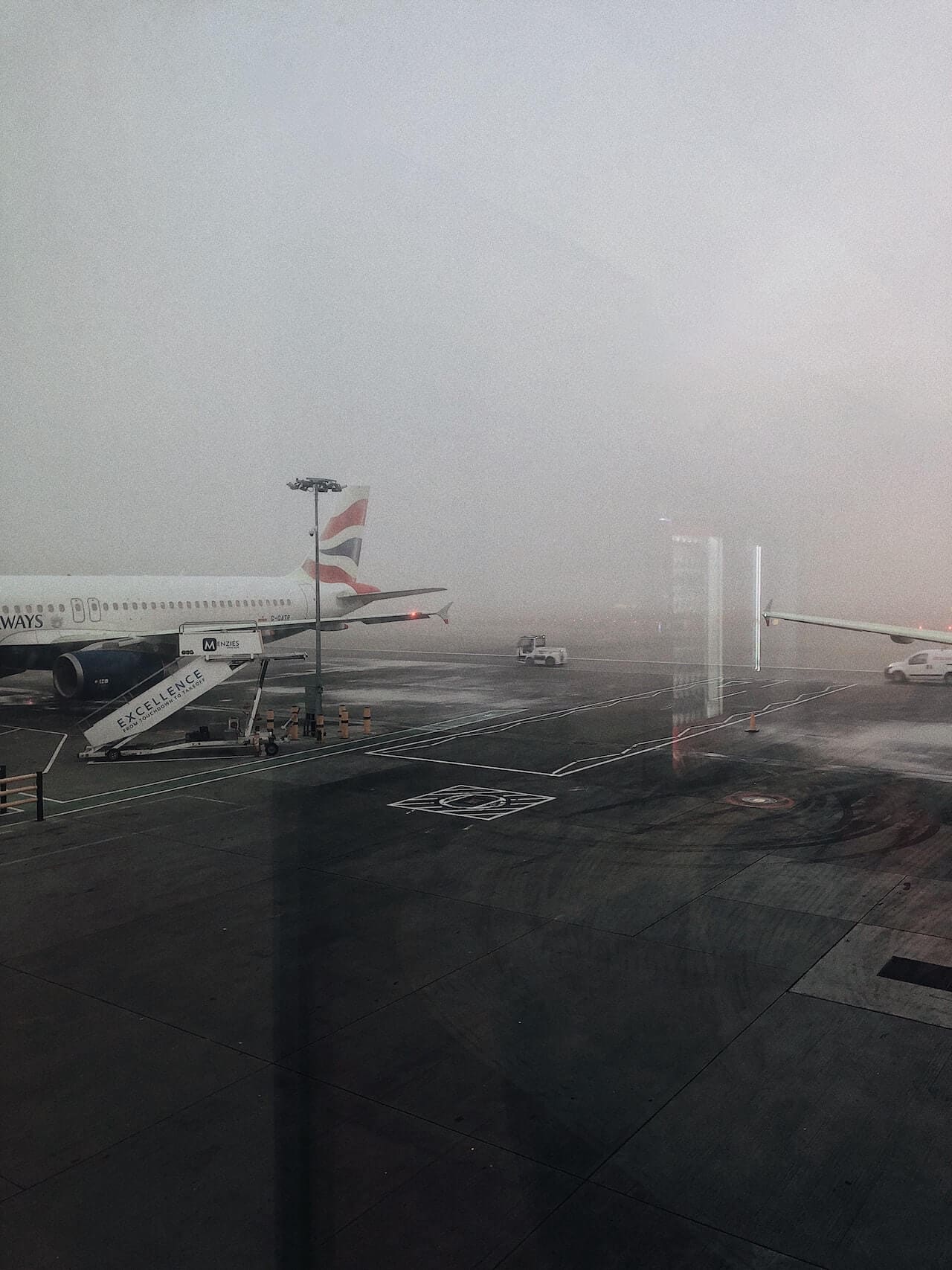 A grounded, delayed plane due to rainy weather conditions