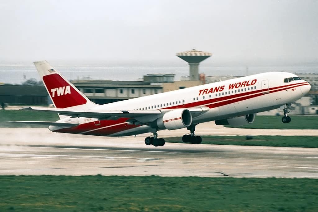 A TWA plane just about to take off in gray skies